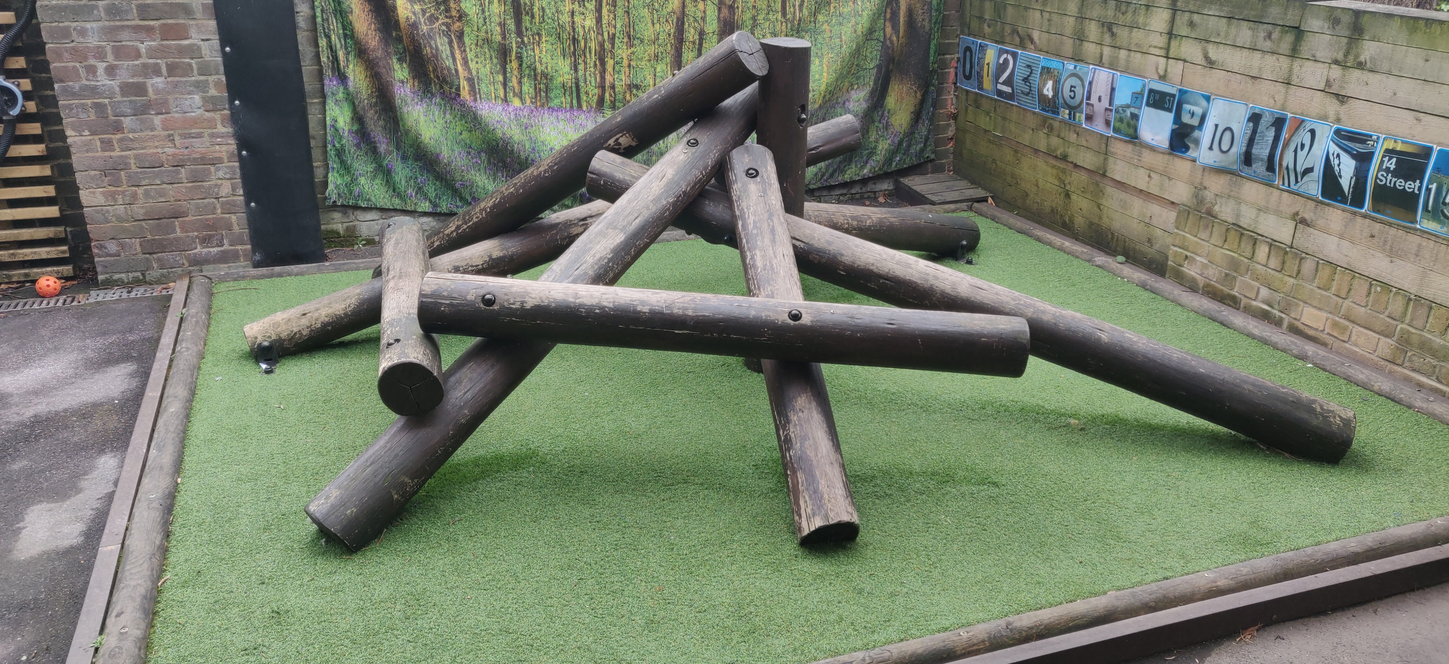 Children climbing a bespoke timber treehouse with rope nets