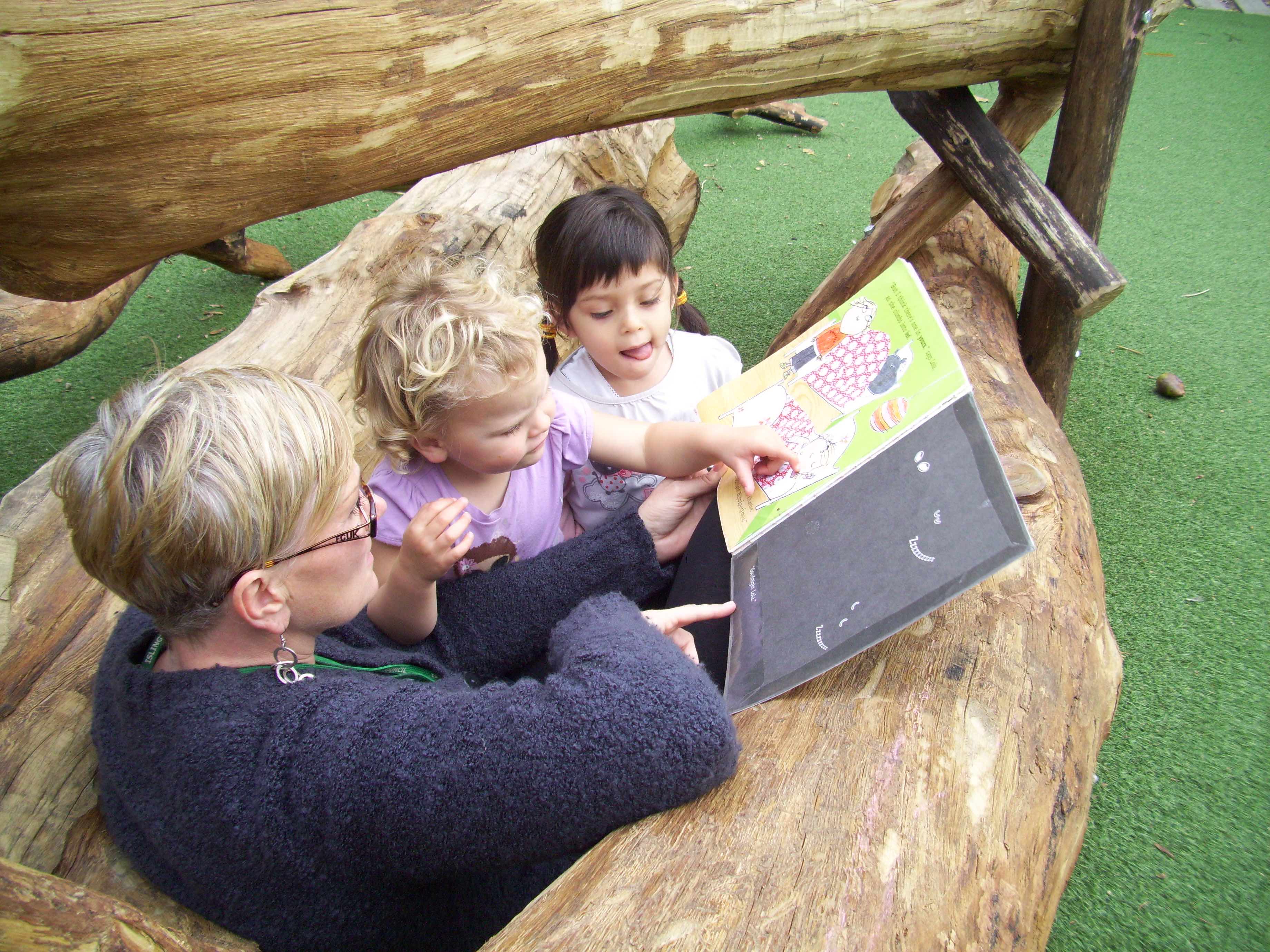 Sensory timber log table at toddler height in a nursery garden