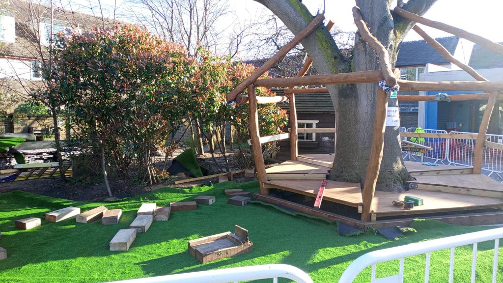 Round timber play shelter with open sides