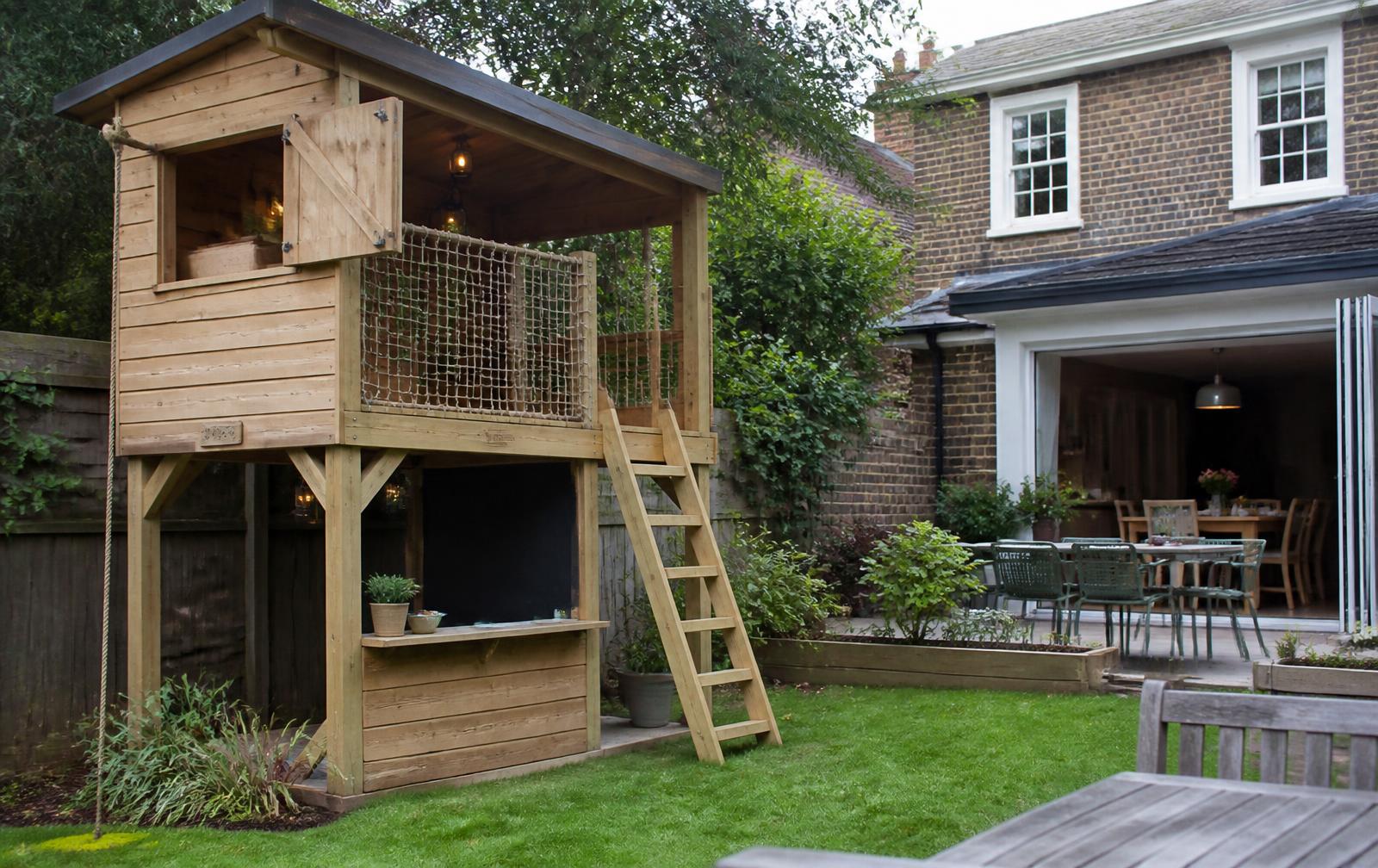 Design concept: raised timber den and playhouse with ladder, net side and role-play counter in the corner of a private family garden